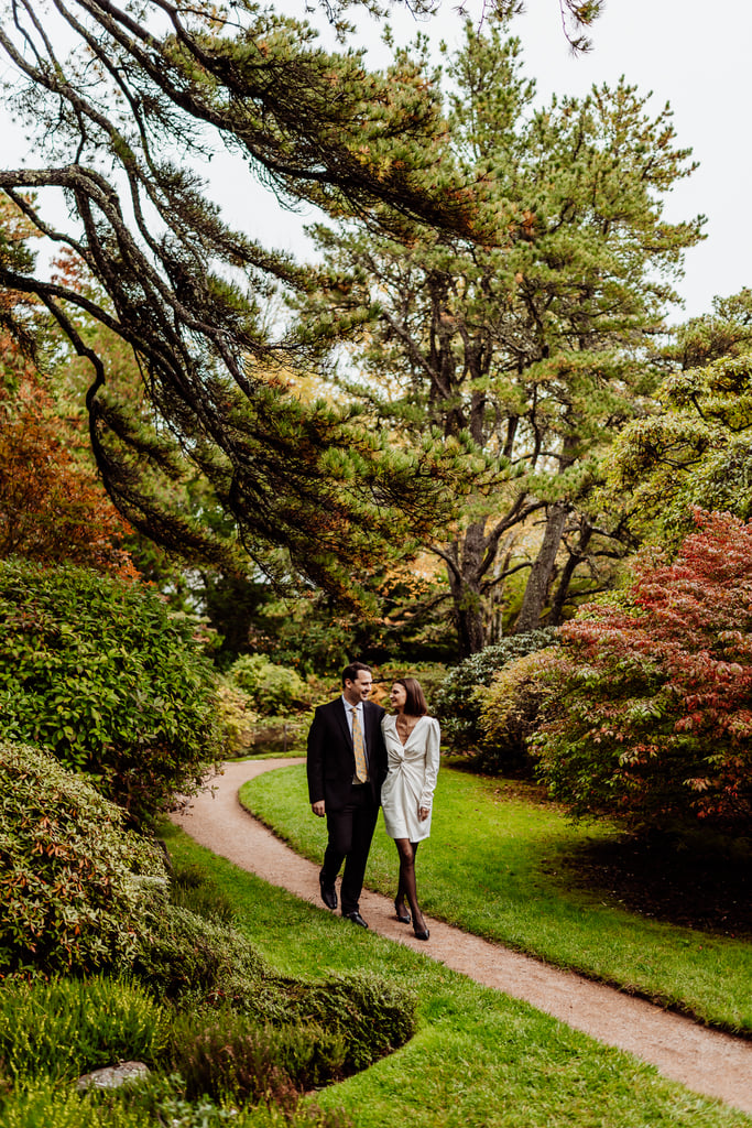 Bride and groom walking together through Asticou Azalea Garden