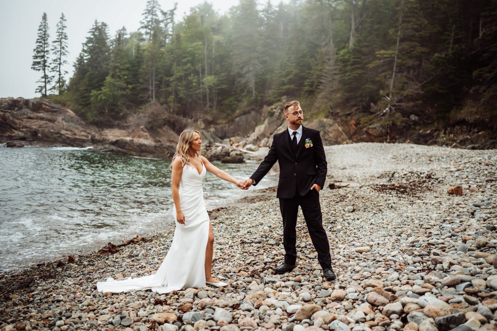 Bride and groom walking on little hunters beach in the fog
