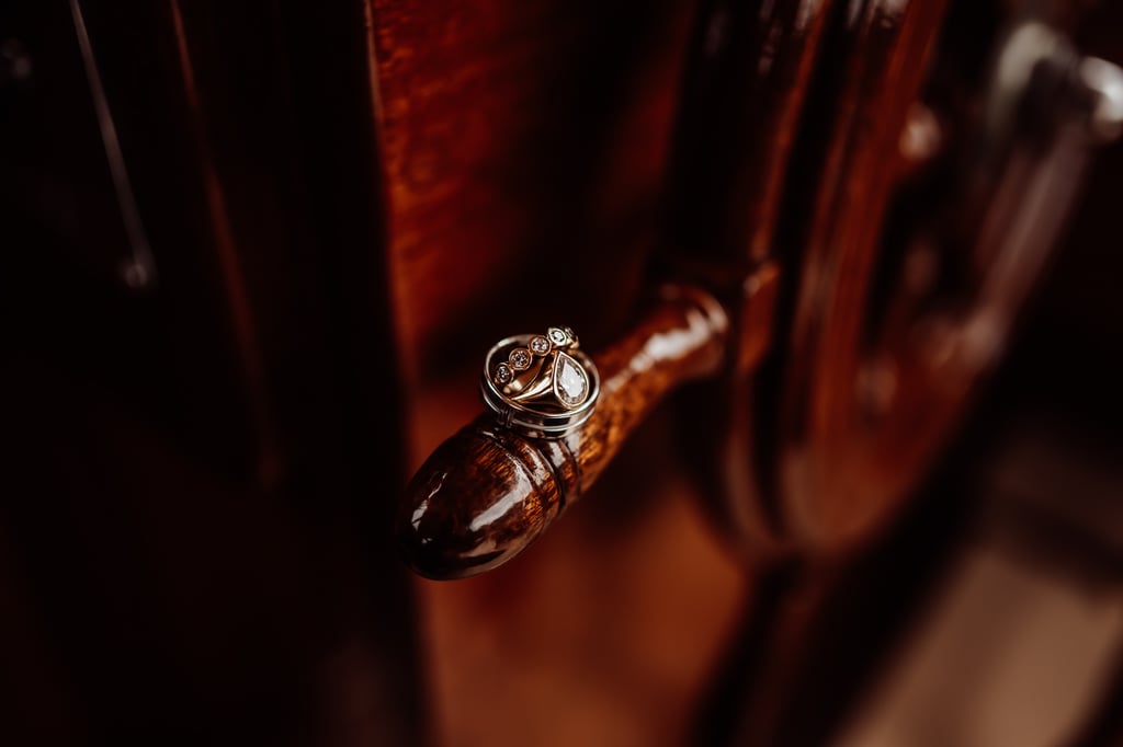 Wedding rings sitting on captains wheel