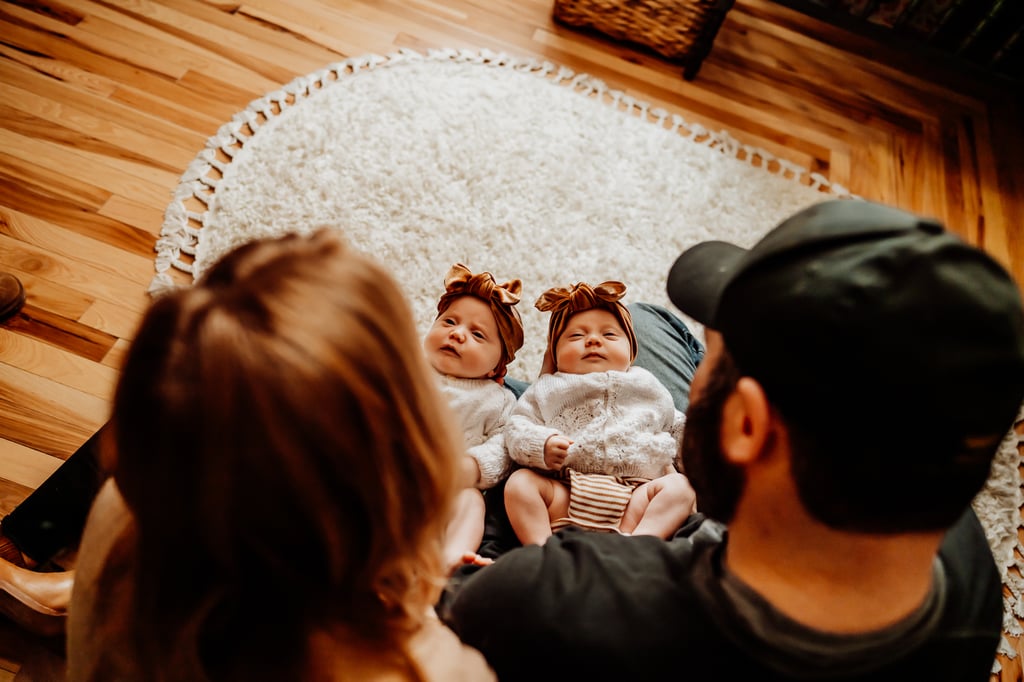 Twin newborn girls posing in home