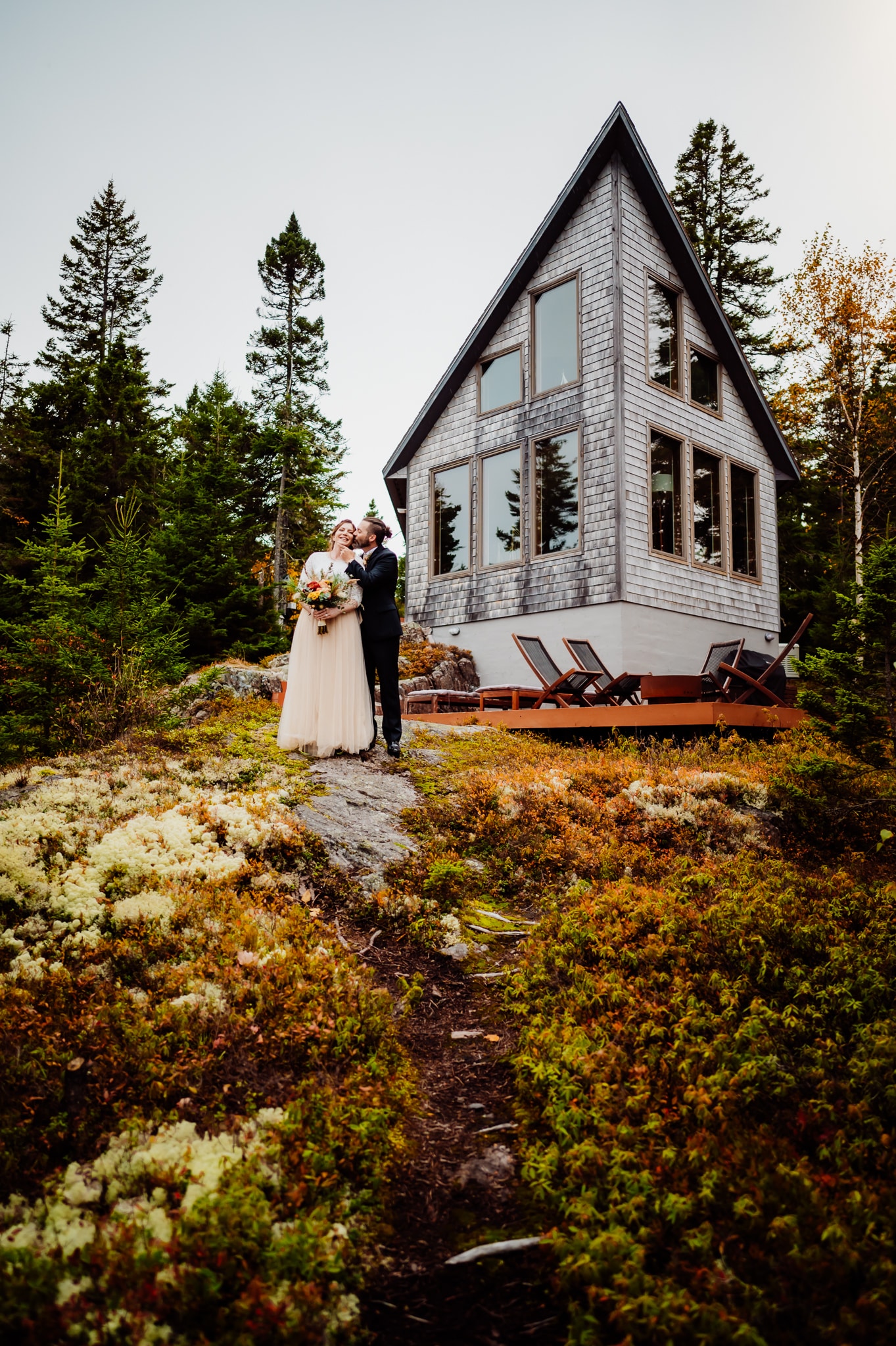 Groom standing together in front of Machias port Airbnb
