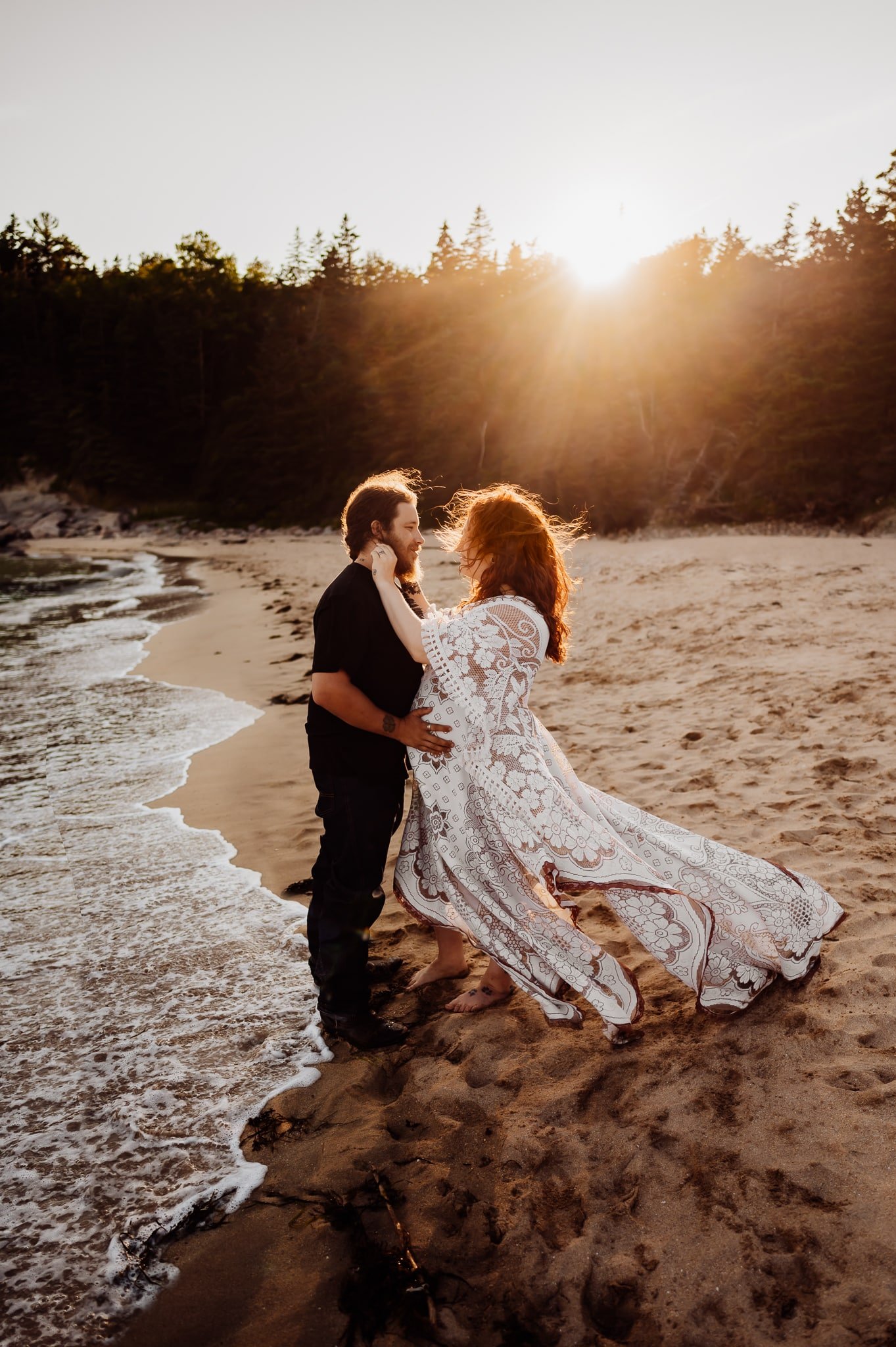 Woman with red hair wearing a big white dress on the beach with husband