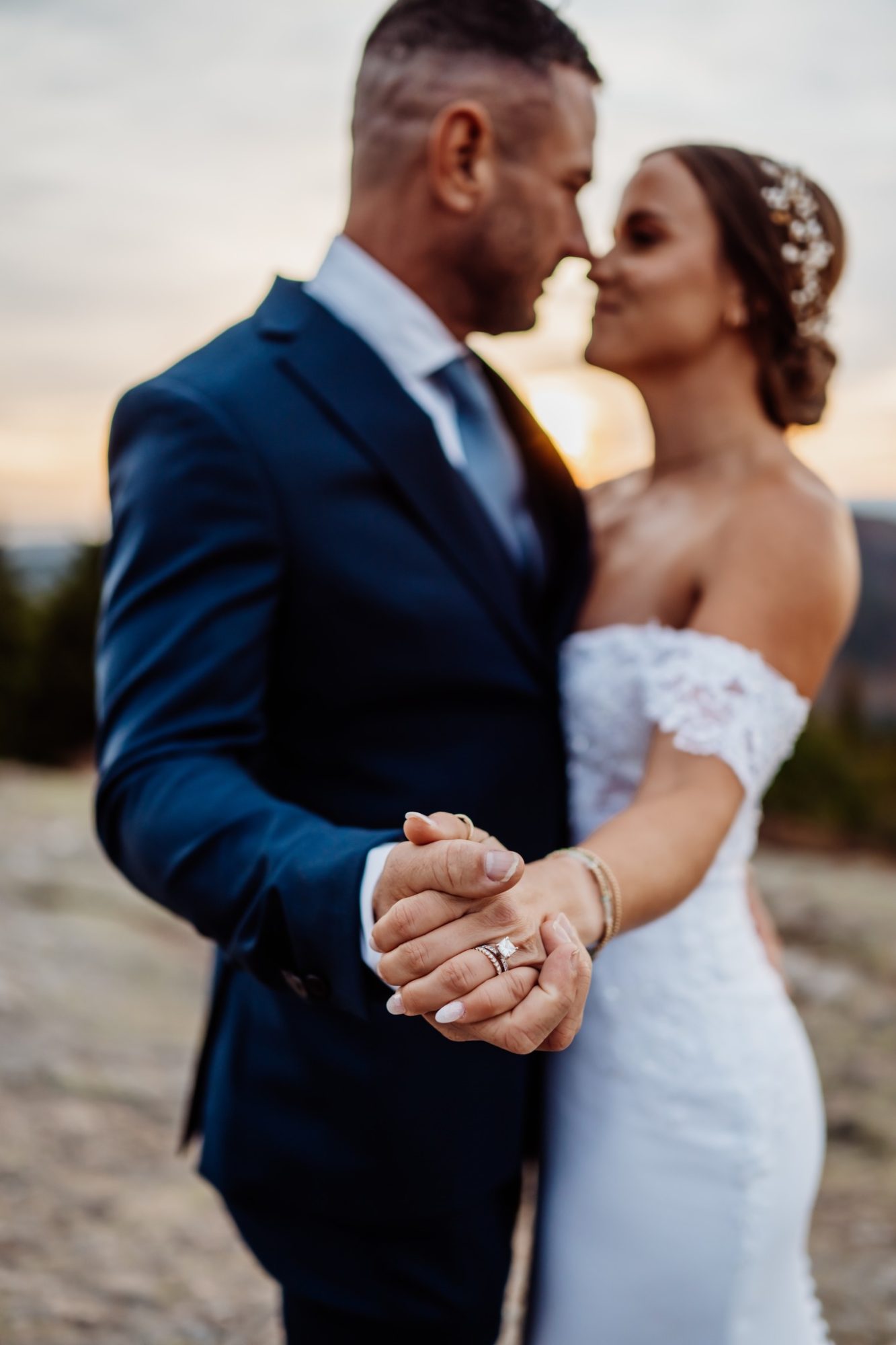 Close-up of bride and groom holding hands during their Schooner Head Overlook elopement in Acadia National Park.
