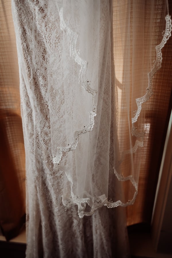 Wedding dress details and veil hanging