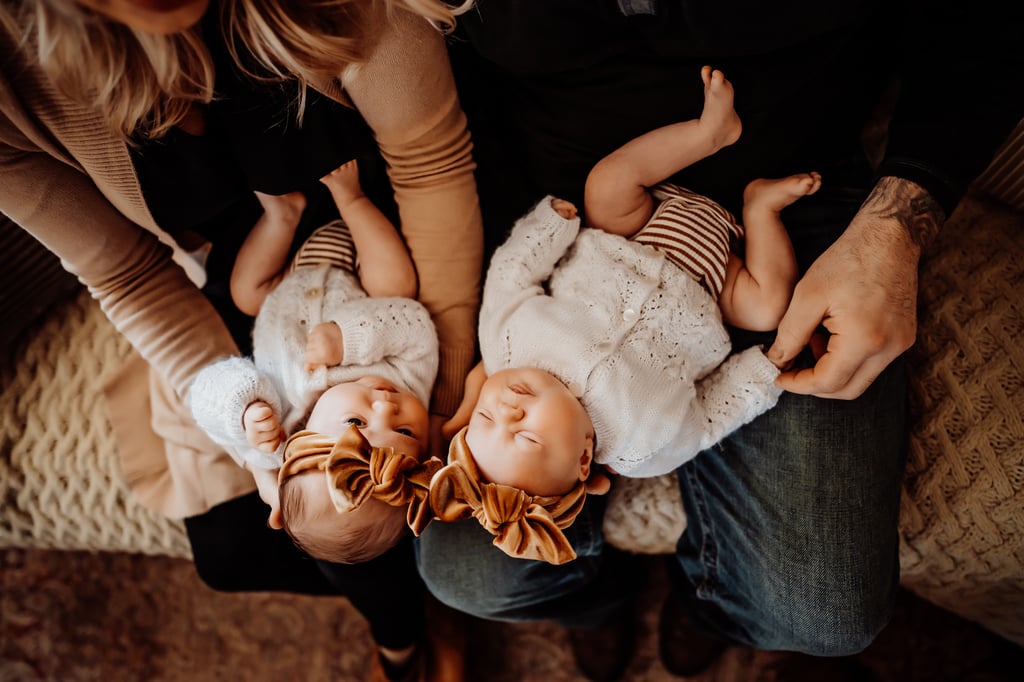 Twin newborn girls posing in home