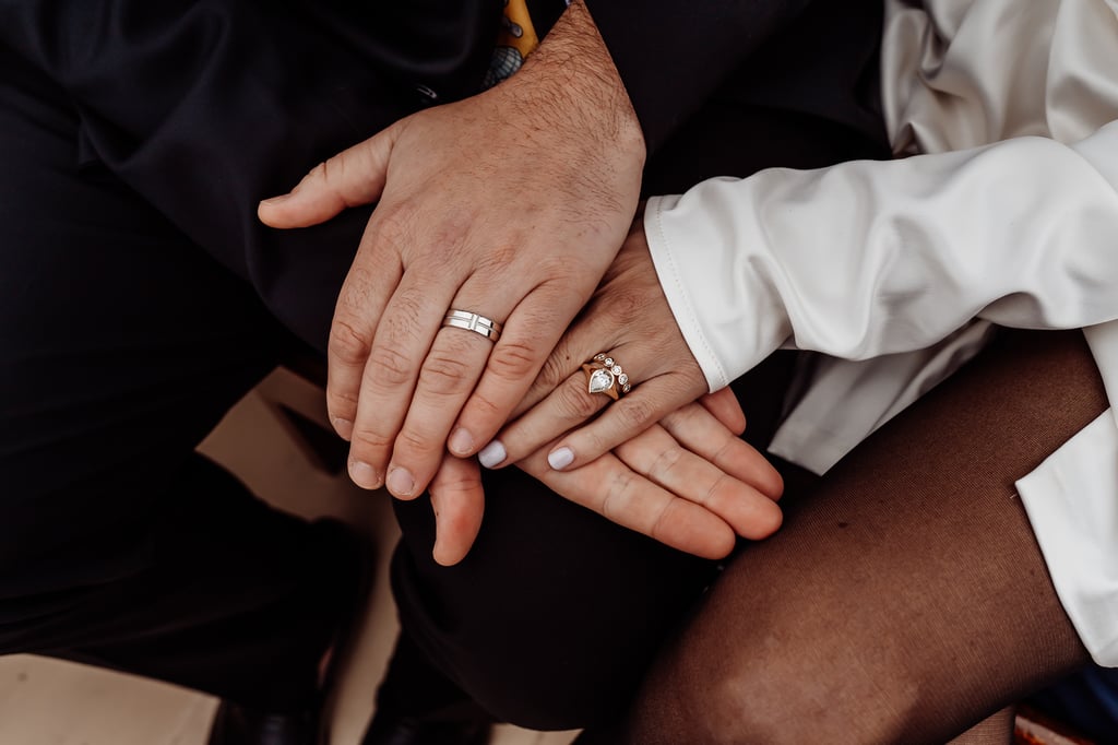 Bride and groom showing new wedding rings on their hands
