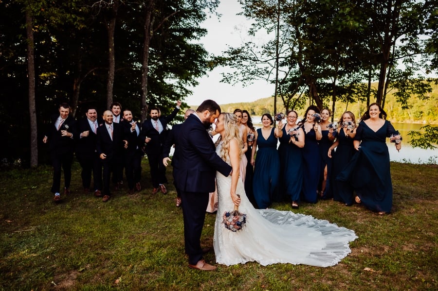 Bride and groom together with bridal party behind running towards them