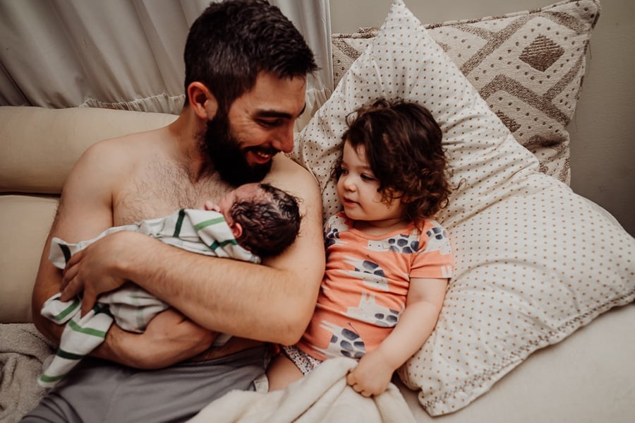 Woman giving birth at home