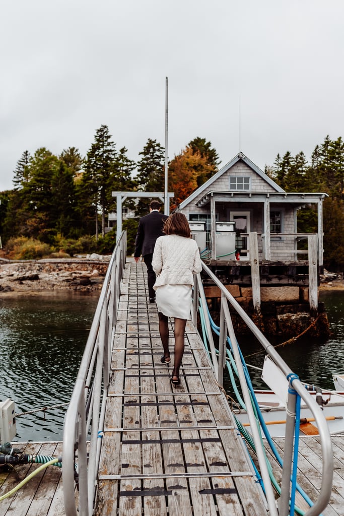 Bride and groom walking up dock in Northeast Harbor, Maine
