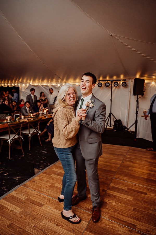 Groom and grandmother dancing at wedding reception