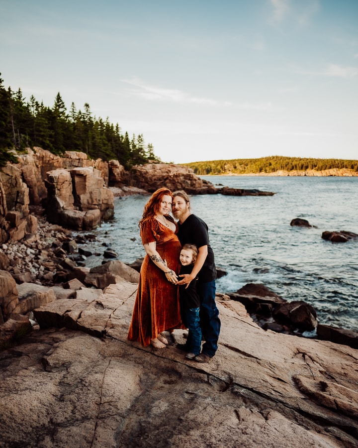 Family hugging on the coast of maine