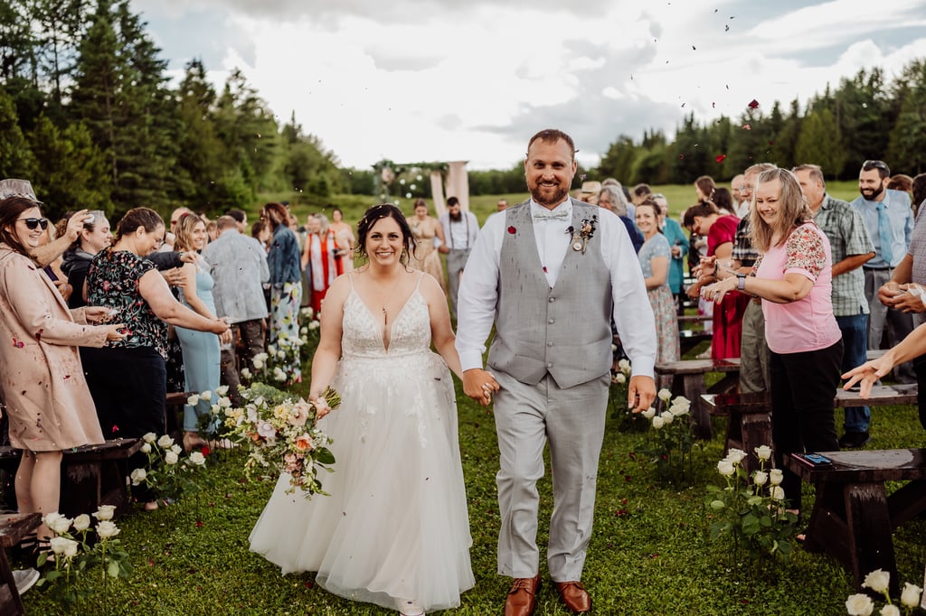 bride and groom leaving wedding ceremony with dried flowers being tossed