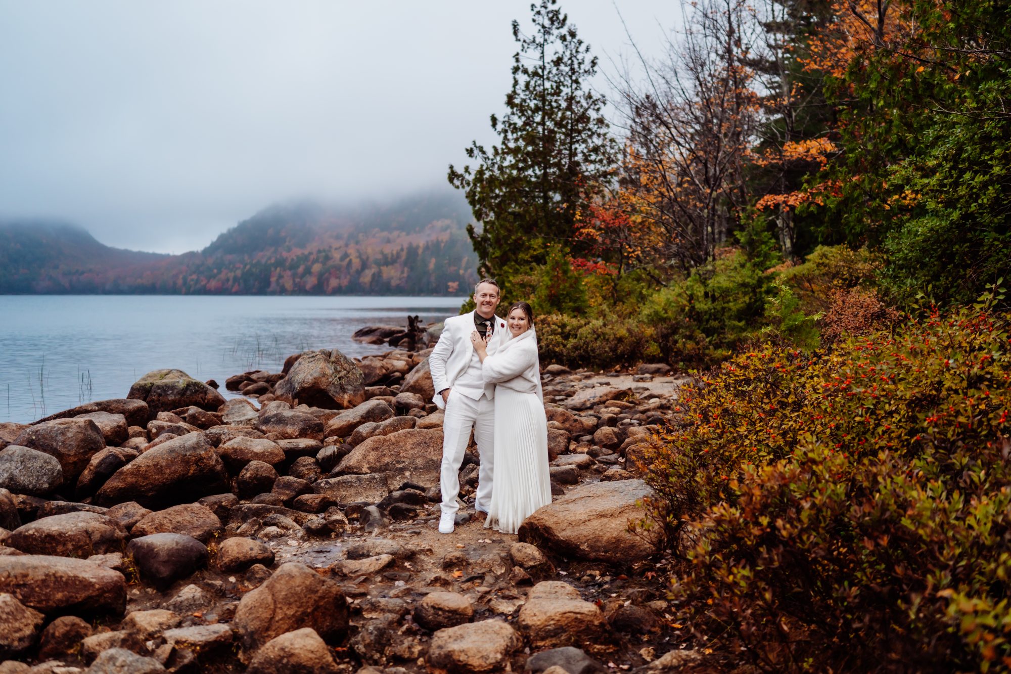 Bride and groom celebrating beside Jordan Pond during their Acadia National Park elopement.