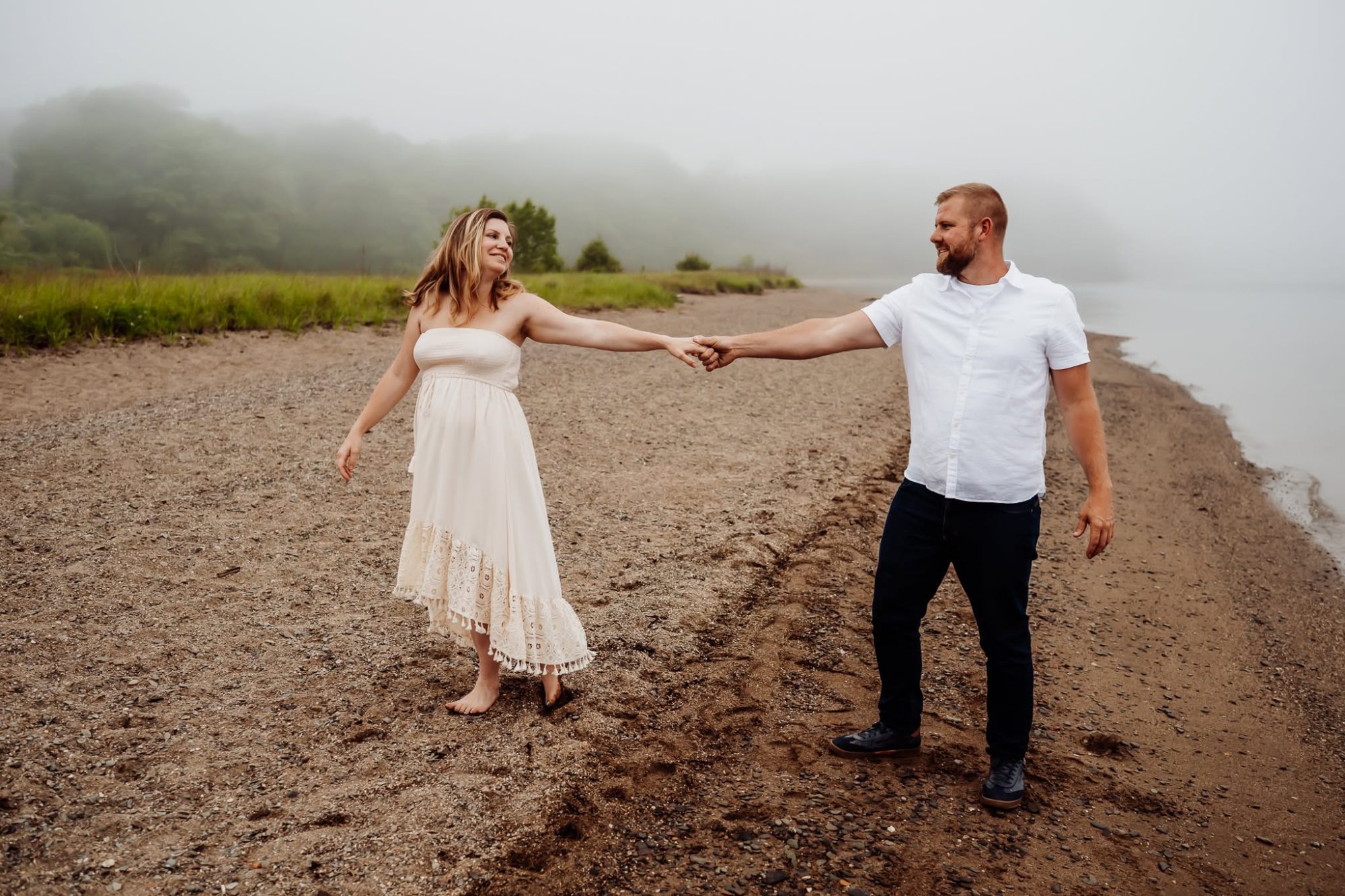 Man and woman on a beach in the fog