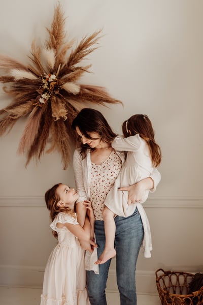 A mother with her two daughters at a photography studio