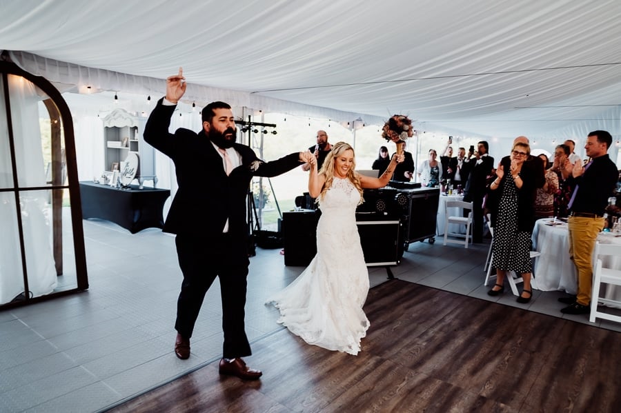 Bride and groom entering reception at the waters edge estate