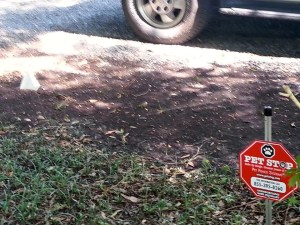 red sign for a "Pet Stop" electronic fence