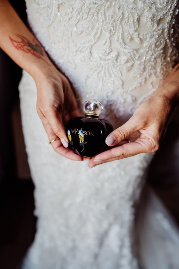bride holding poison perfume in hands