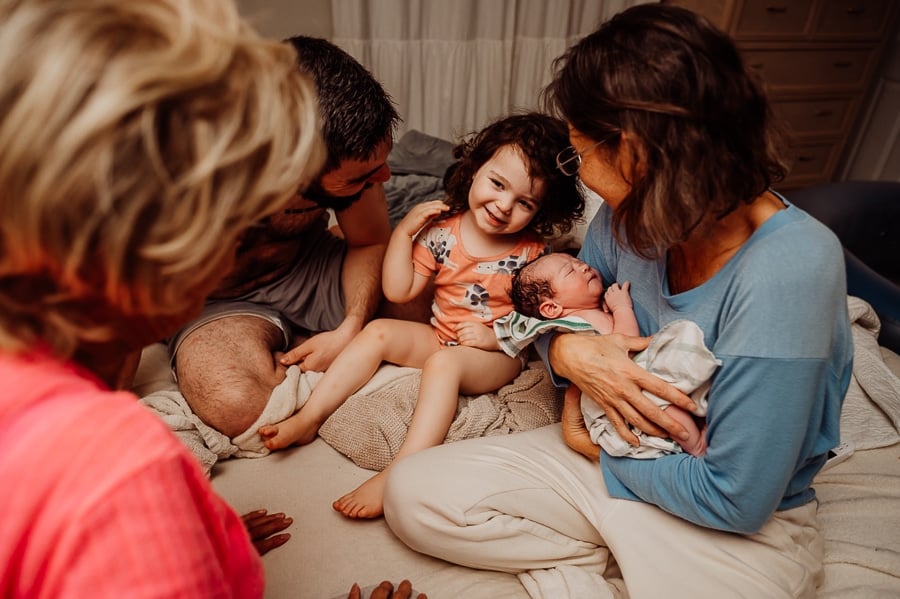 Woman giving birth at home