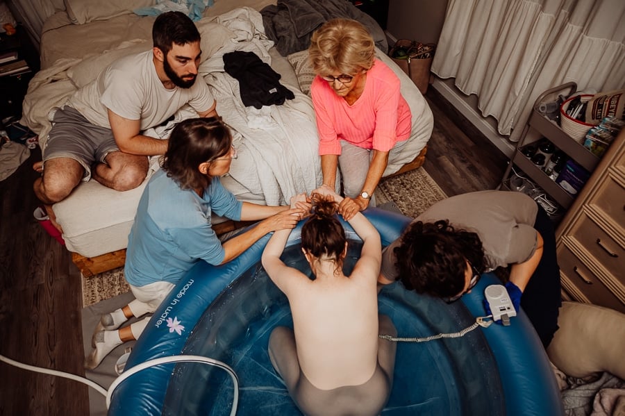 Mother giving birth at home