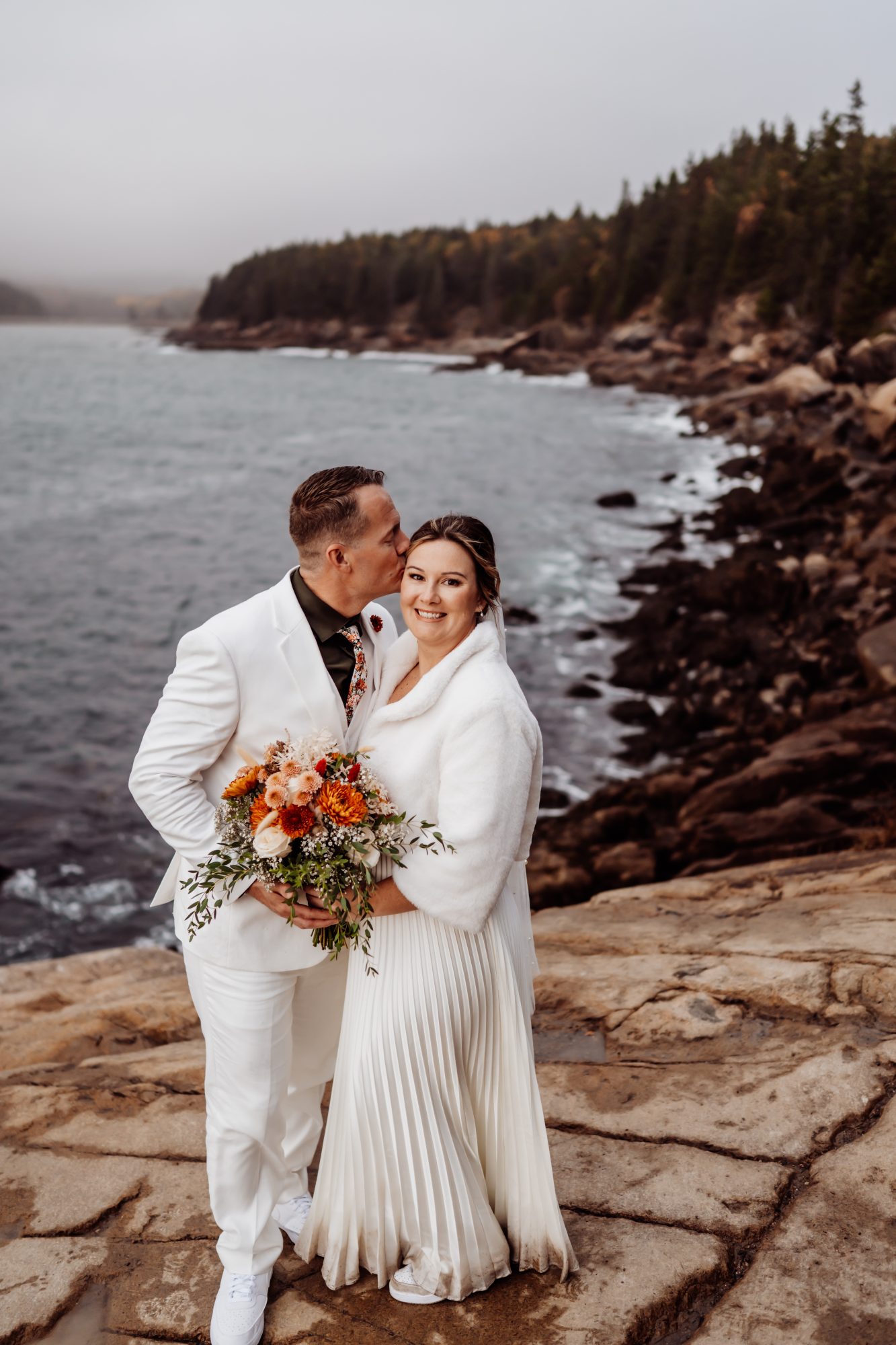 Bride and groom overlooking Atlantic Ocean during Thunder Hole elopement in Acadia.