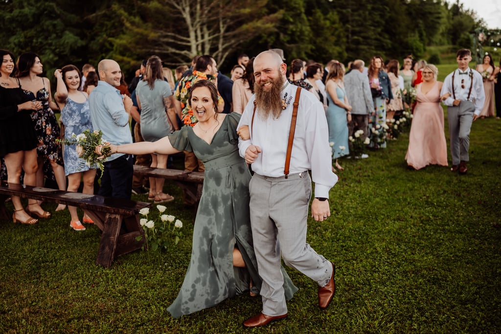 bridesmaid and groomsman leaving ceremony soaked from rain