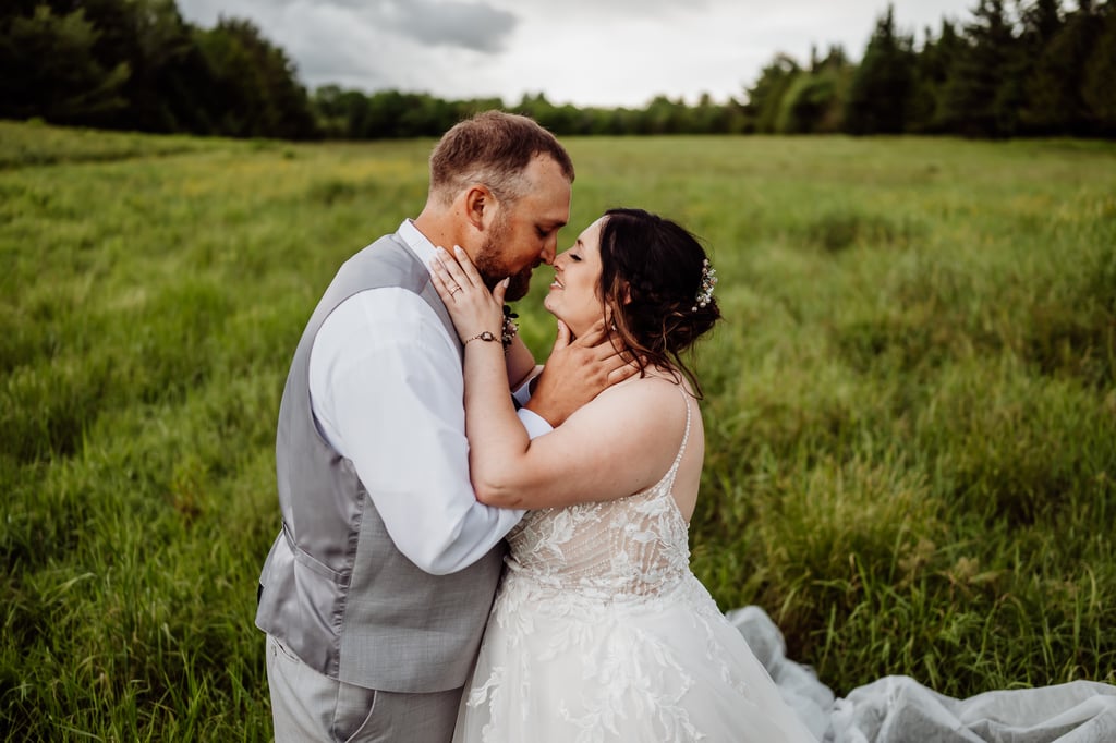 bride and groom facing each other holding each others faces