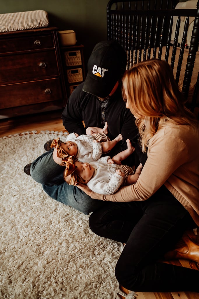 Twin newborn girls posing in home