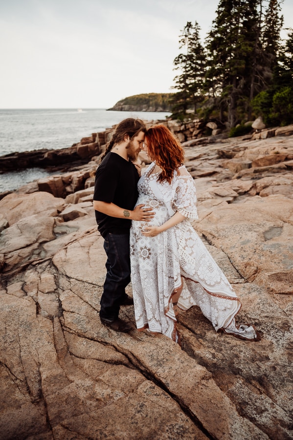 man and woman wearing white lace dress on acadia cliffs