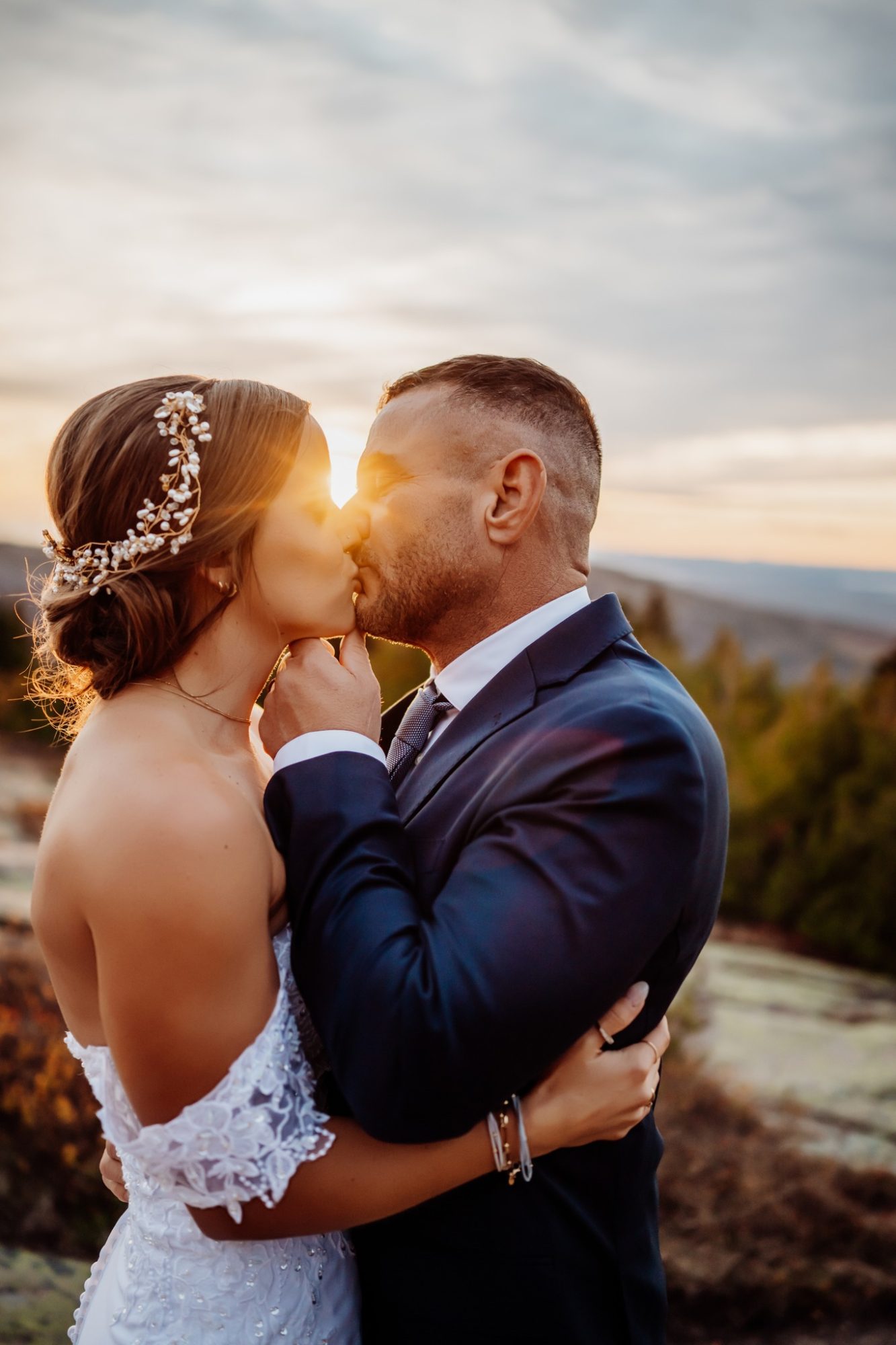 Bride and groom sharing a sunset kiss during their elopement at Schooner Head Overlook in Acadia National Park.