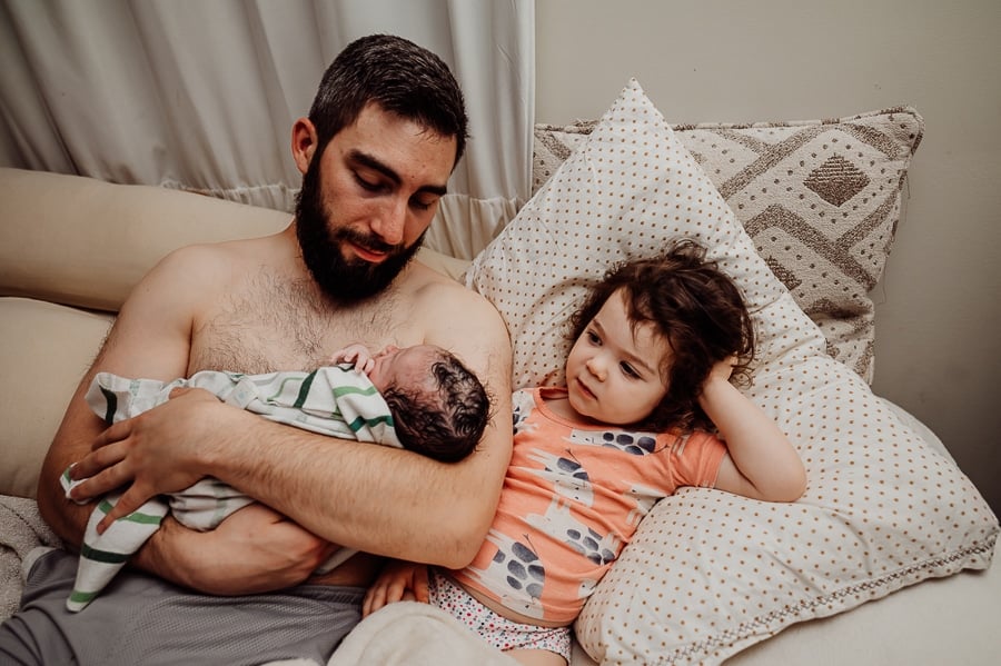 Woman giving birth at home