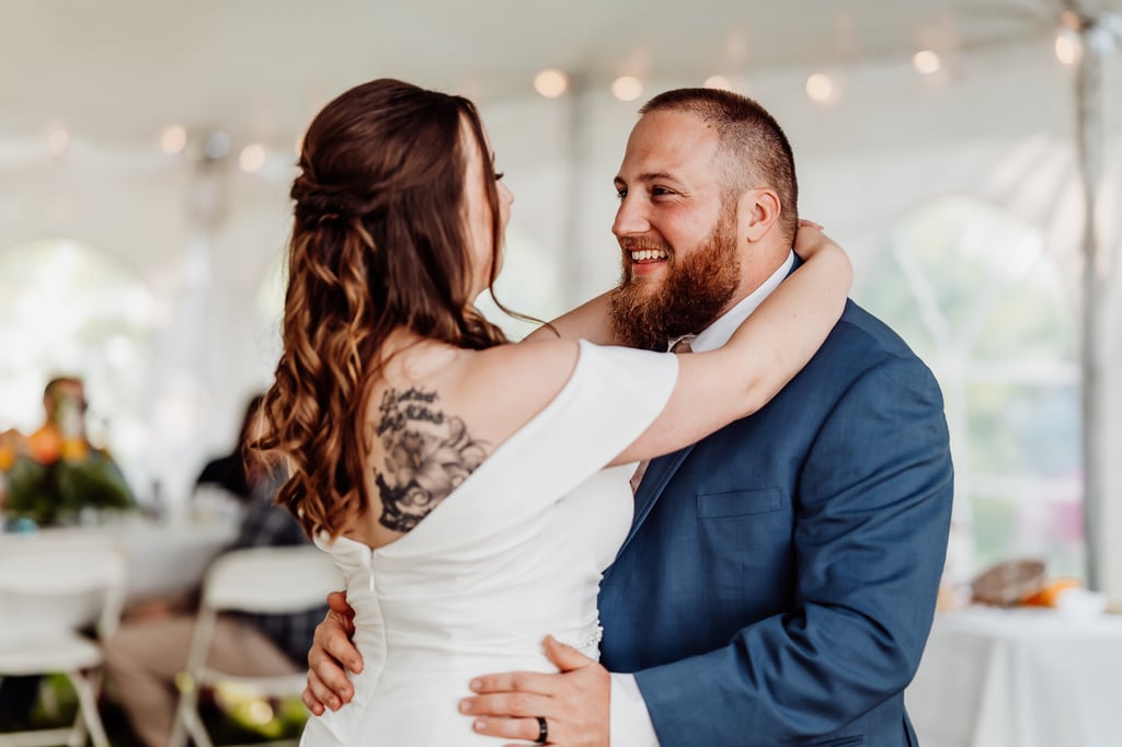 The bride and groom smile at each other during their first dance.