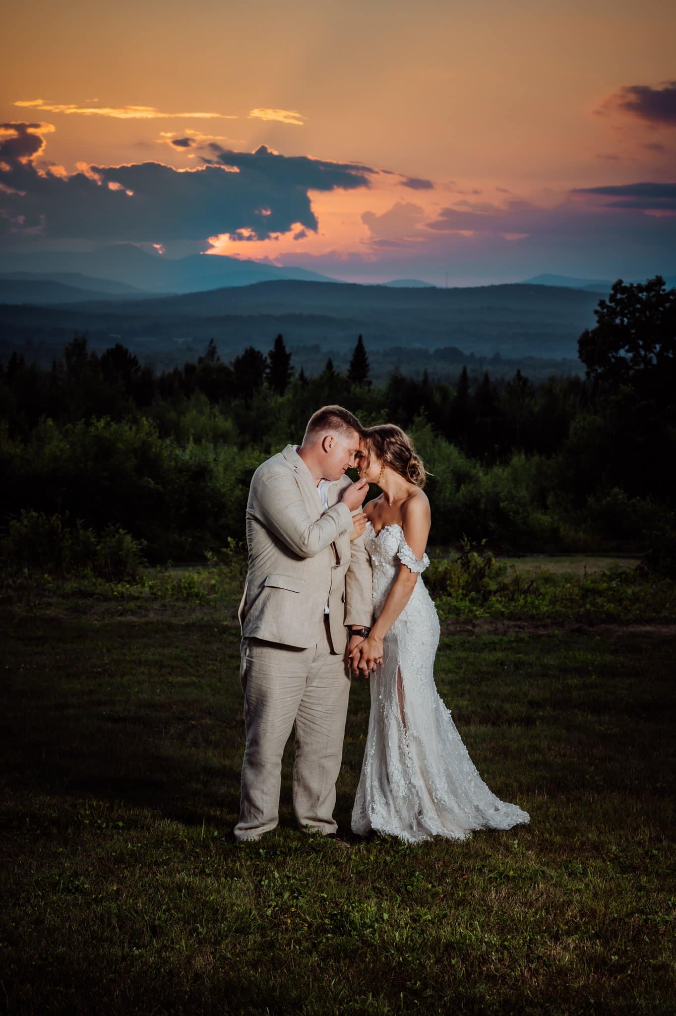 bride and groom at sunset with red skies