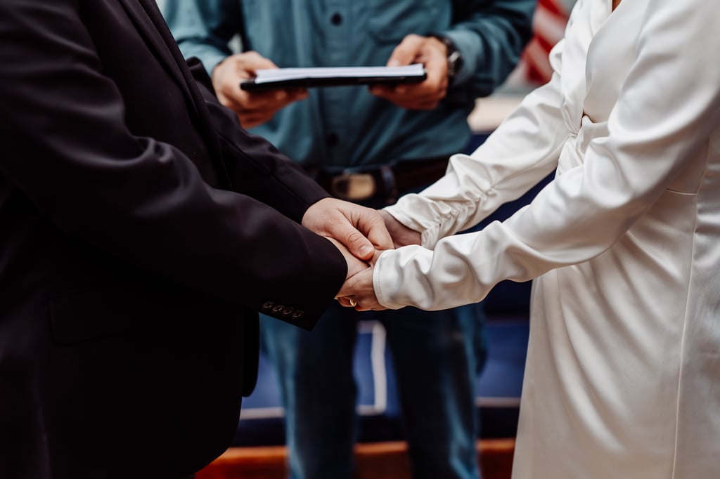 Bride and groom holding hands at wedding ceremony on a boat