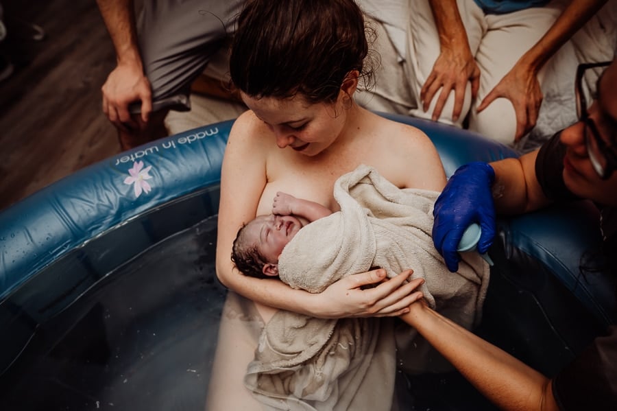 Mother giving birth at home
