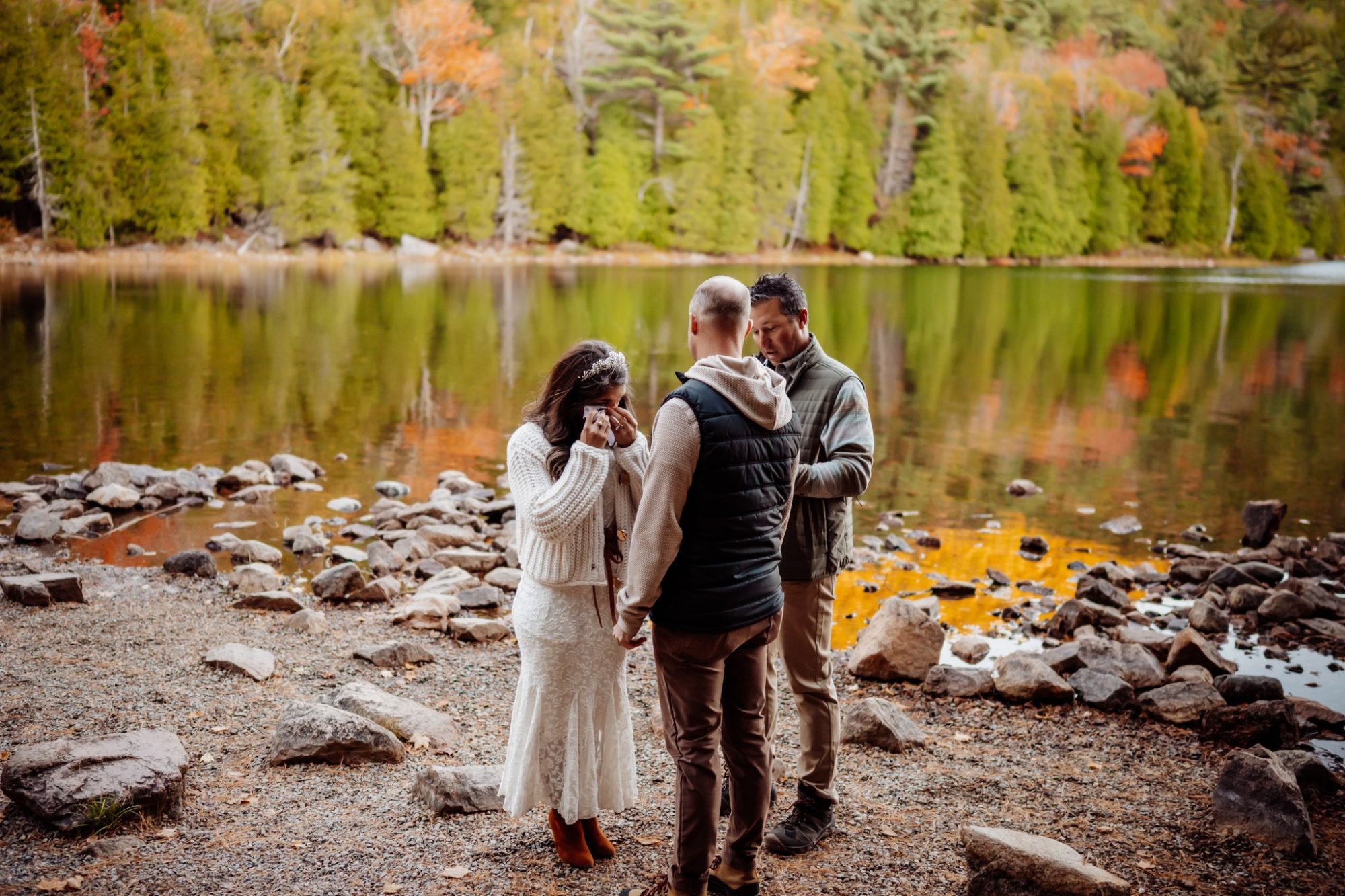 Small lakeside vow exchange at Jordan Pond during fall ceremony in Acadia National Park.