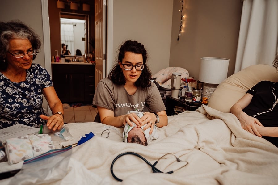 Woman giving birth at home