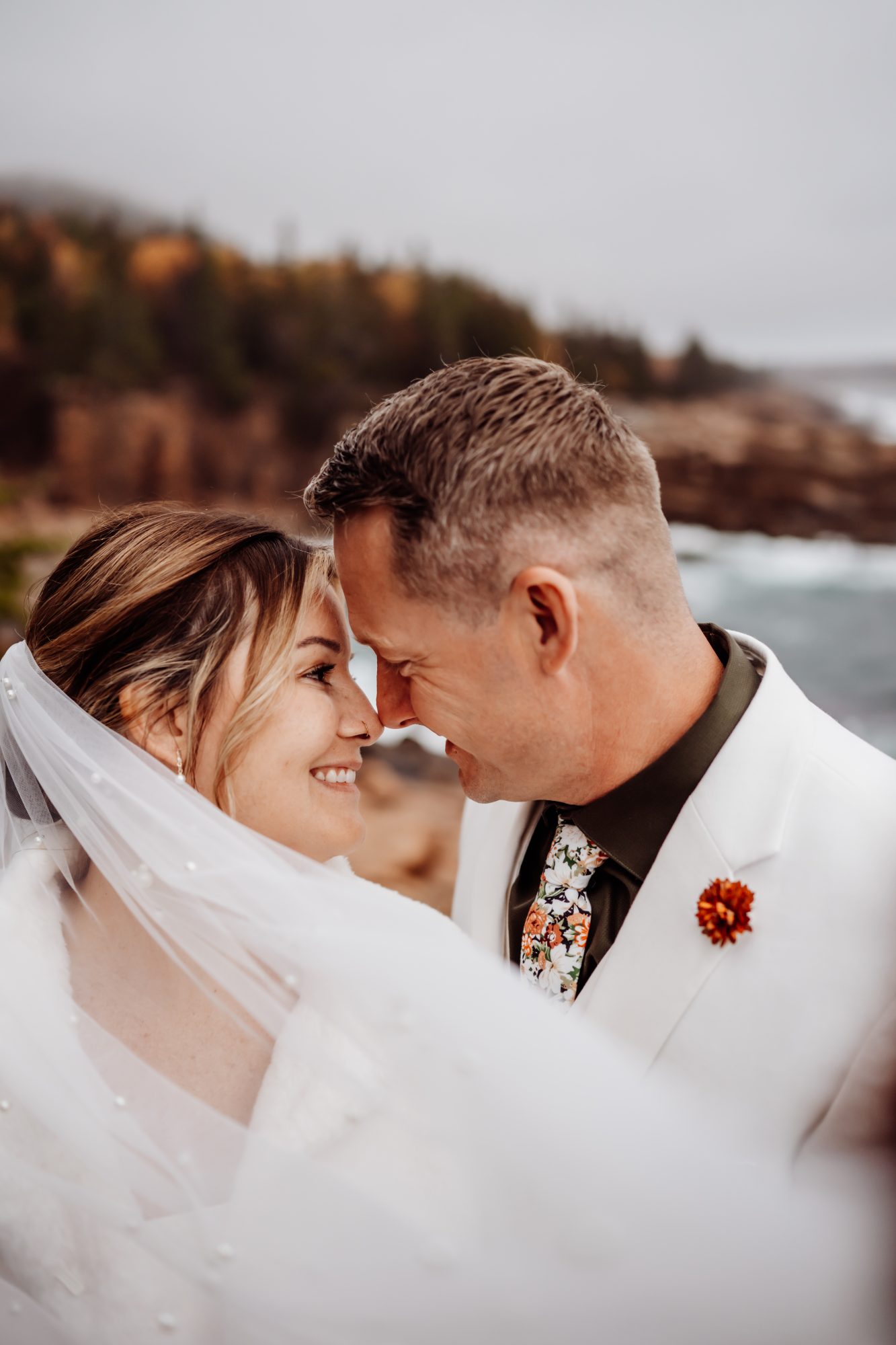 Romantic veil portrait during a coastal elopement at Thunder Hole in Acadia National Park.