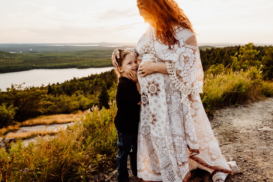Son hugging mothers belly in bar harbor maine
