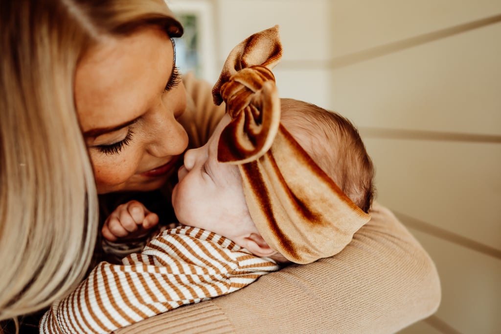 Twin newborn girls posing in home
