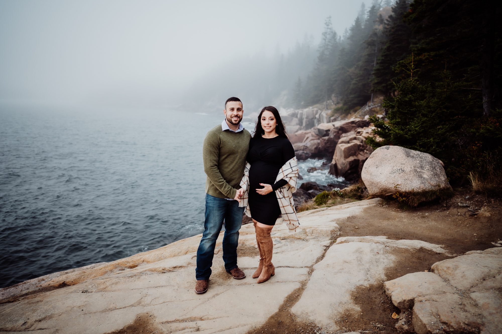 Couple standing on otter cliffs in the fog
