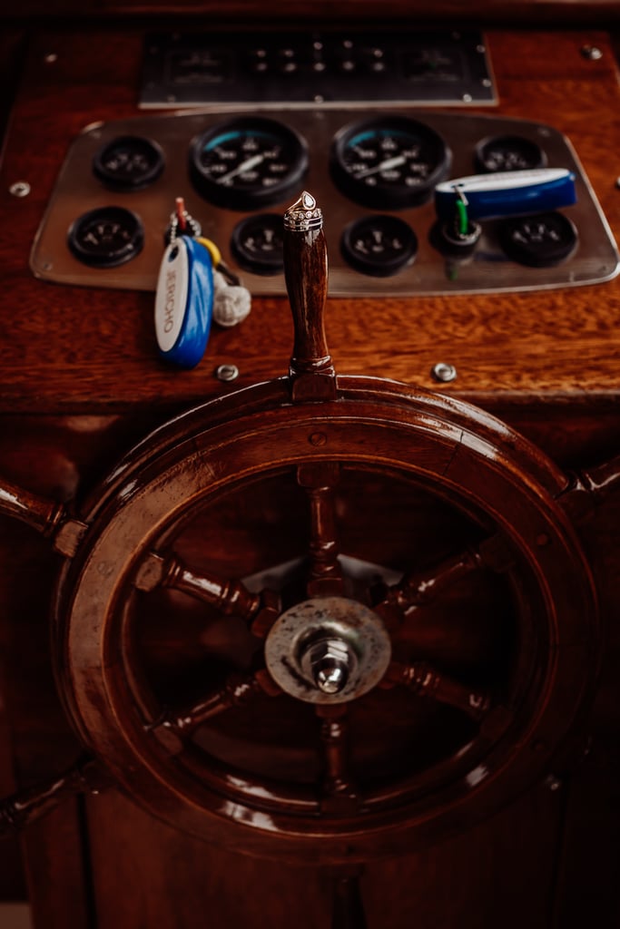 Wedding rings sitting on top of boat wheel