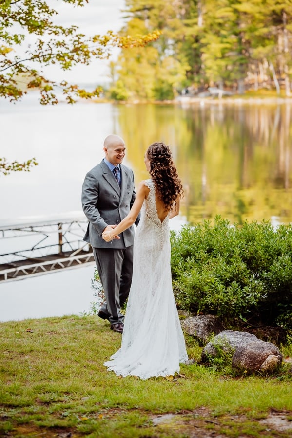 bride and groom first look in front of millinocket lake