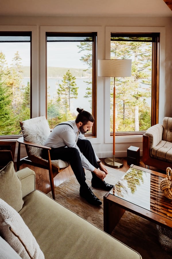 Groom putting on shoes in machiasport airbnb