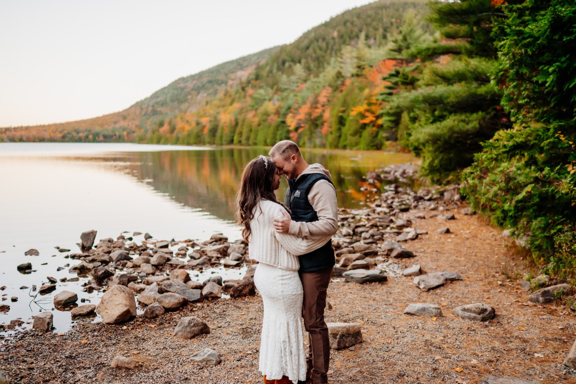 Intimate lakeside embrace with vibrant fall foliage at Jordan Pond in Acadia.
