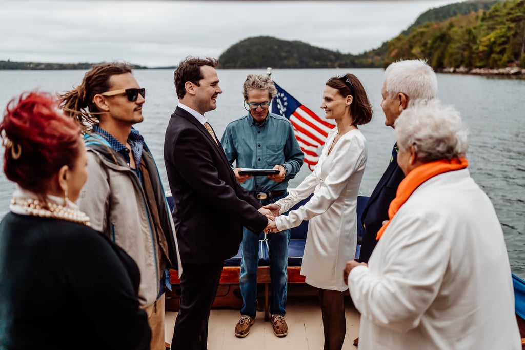 Bride and groom exchanging wedding vows on a boat