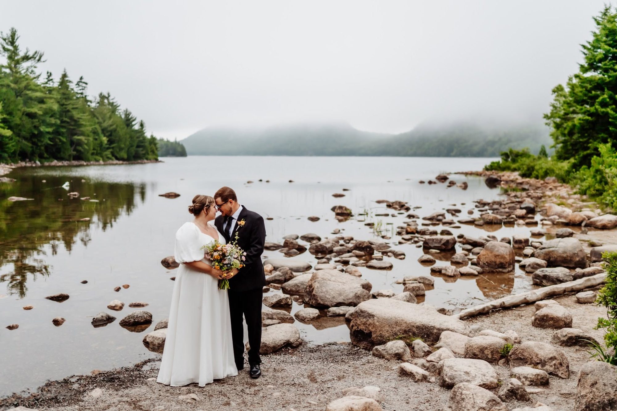 Bride and groom at jordan pond in the fog
