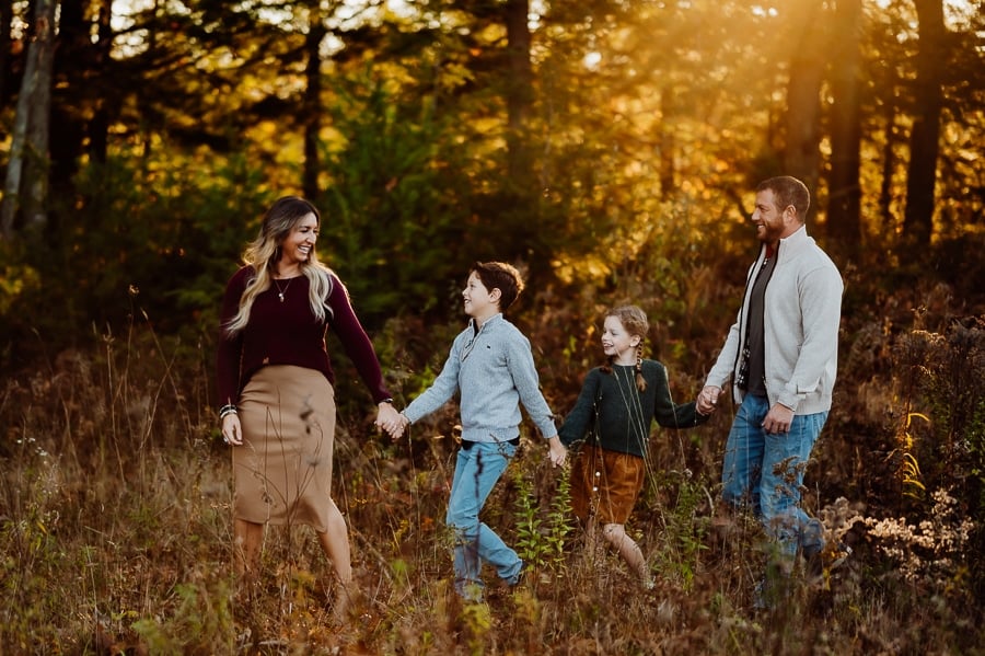 Family holding hands walking together in a line