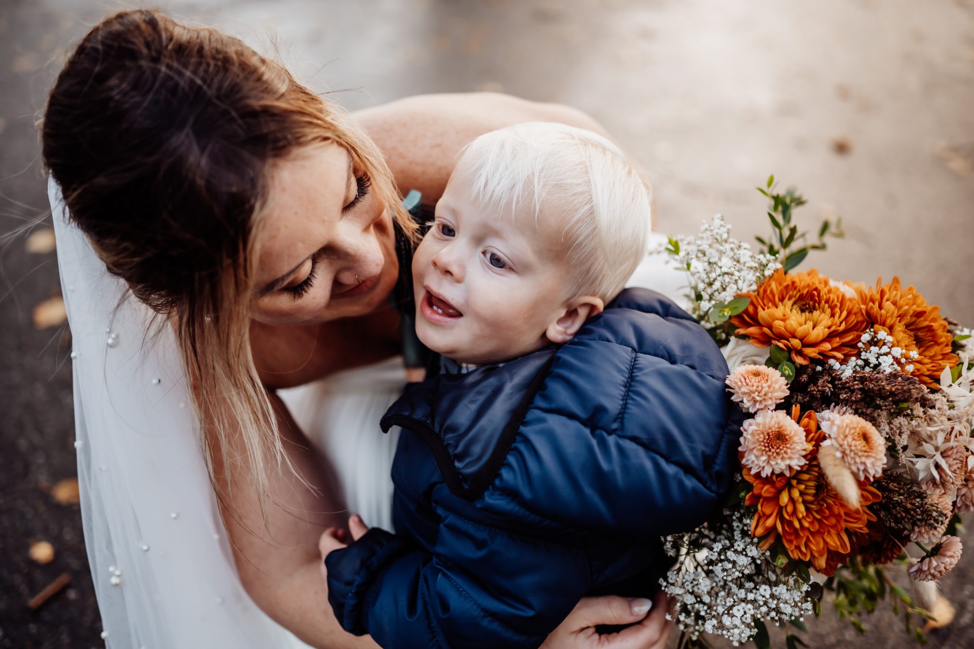 Mother hugging toddler during intimate Acadia elopement celebration.