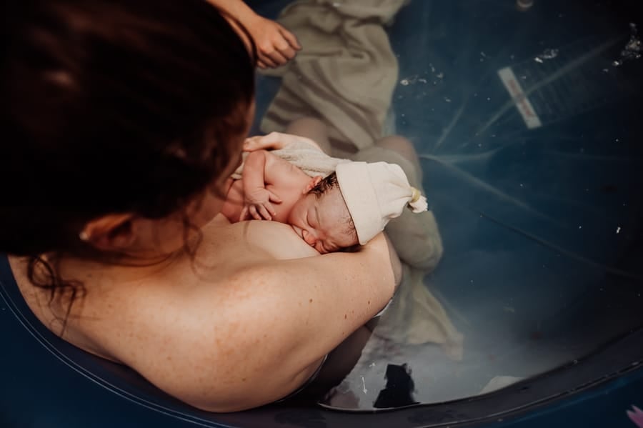 Woman giving birth at home in Maine
